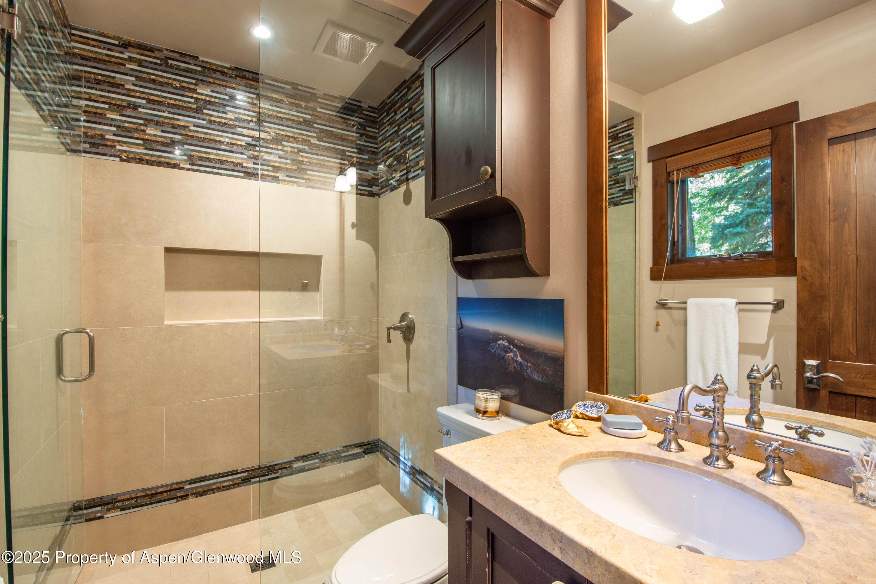 4076 Lower River Road Snowmass, CO 81654 - Photo 36 of 71 a bathroom with a sink a toilet a mirror and shower