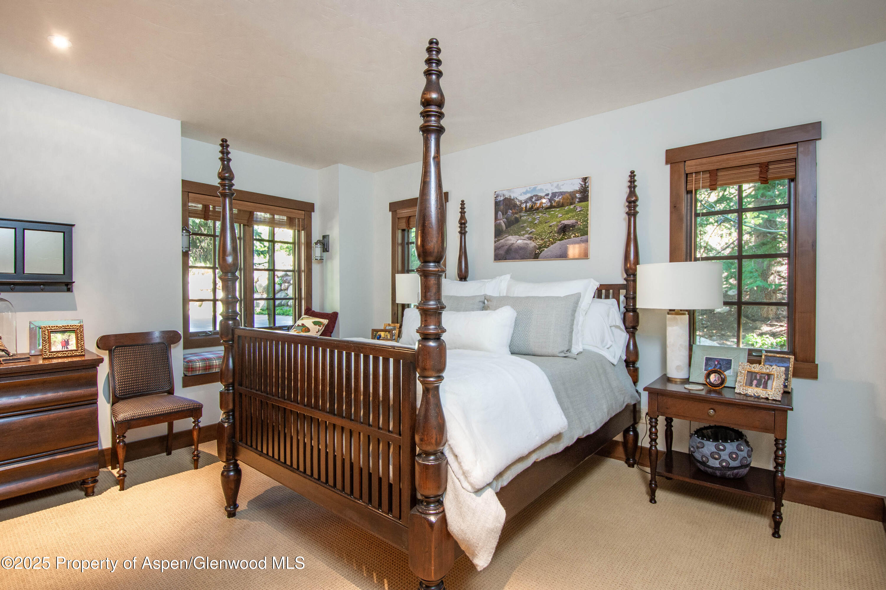 4076 Lower River Road Snowmass, CO 81654 - Photo 37 of 71 a spacious bedroom with a bed and a window