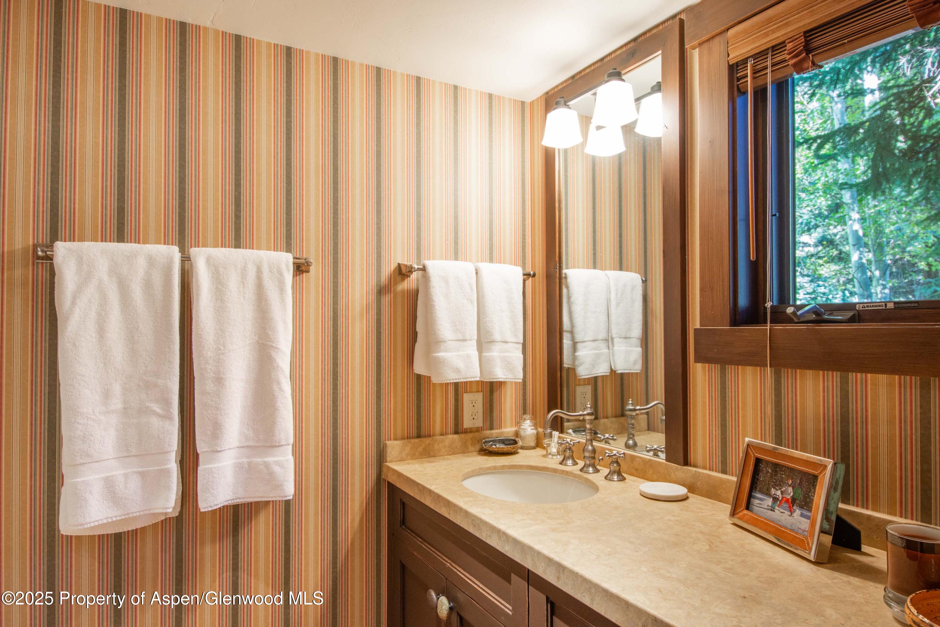 4076 Lower River Road Snowmass, CO 81654 - Photo 39 of 71 a bathroom with a sink and a mirror