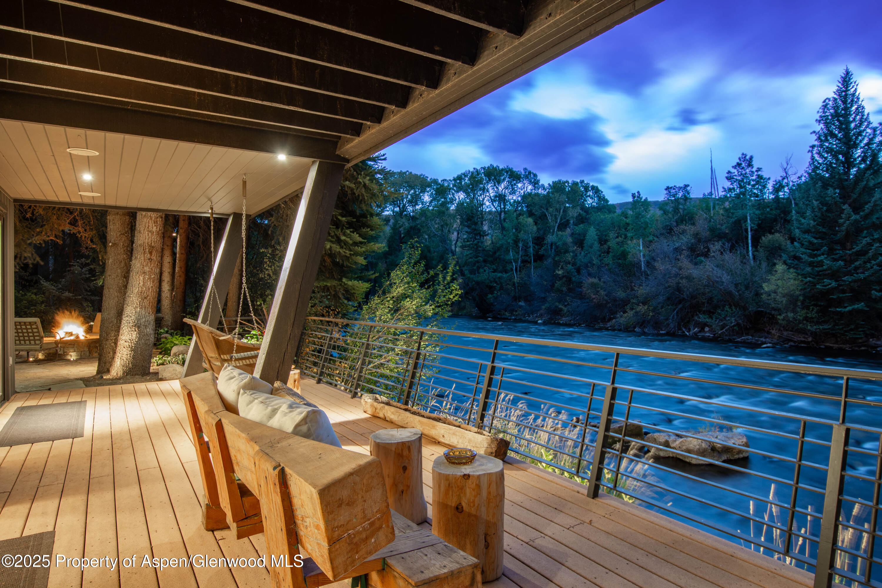 4076 Lower River Road Snowmass, CO 81654 - Photo 4 of 71 a view of a patio with table and chairs with wooden floor and fence