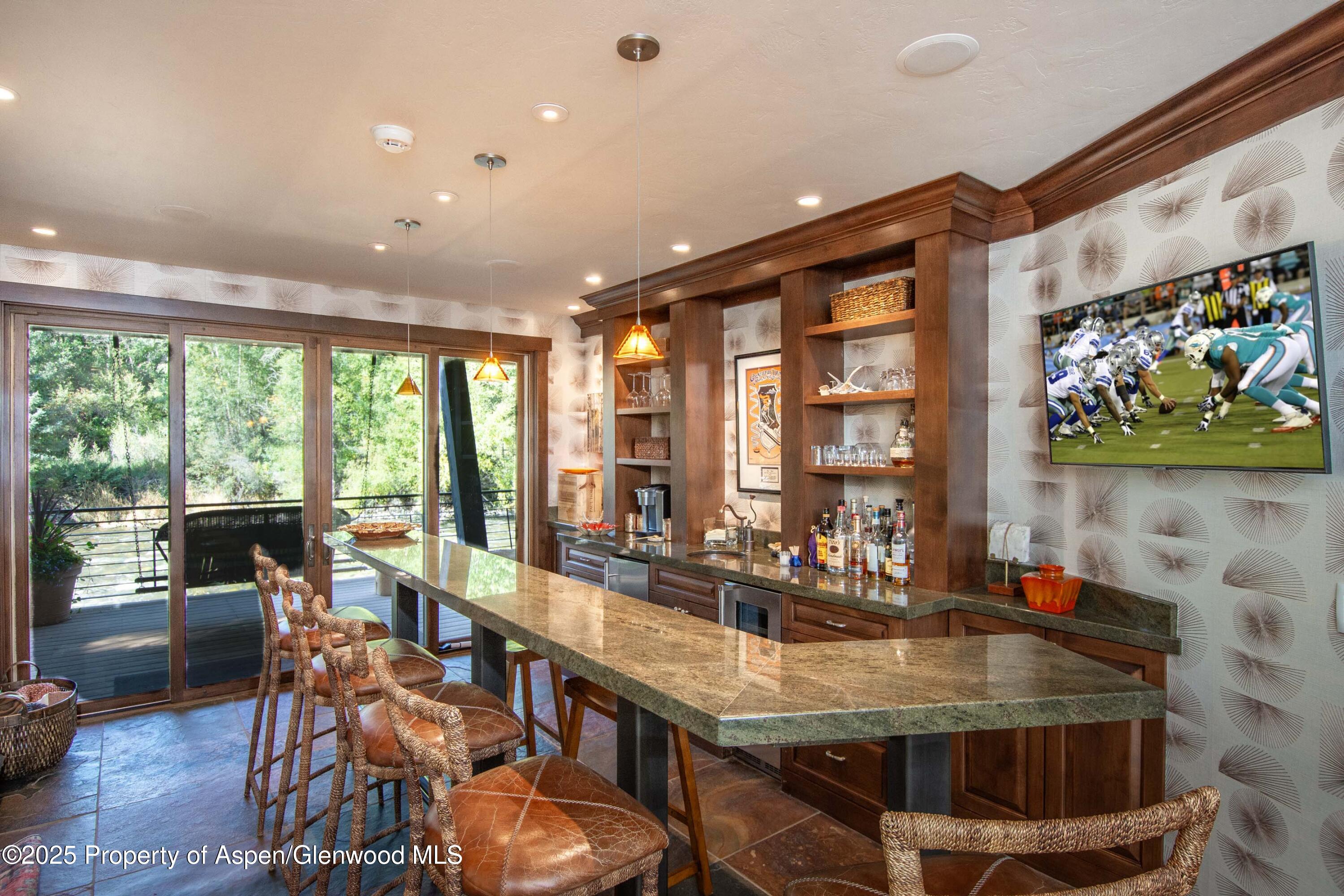 4076 Lower River Road Snowmass, CO 81654 - Photo 41 of 71 a dining room with furniture water view and large windows