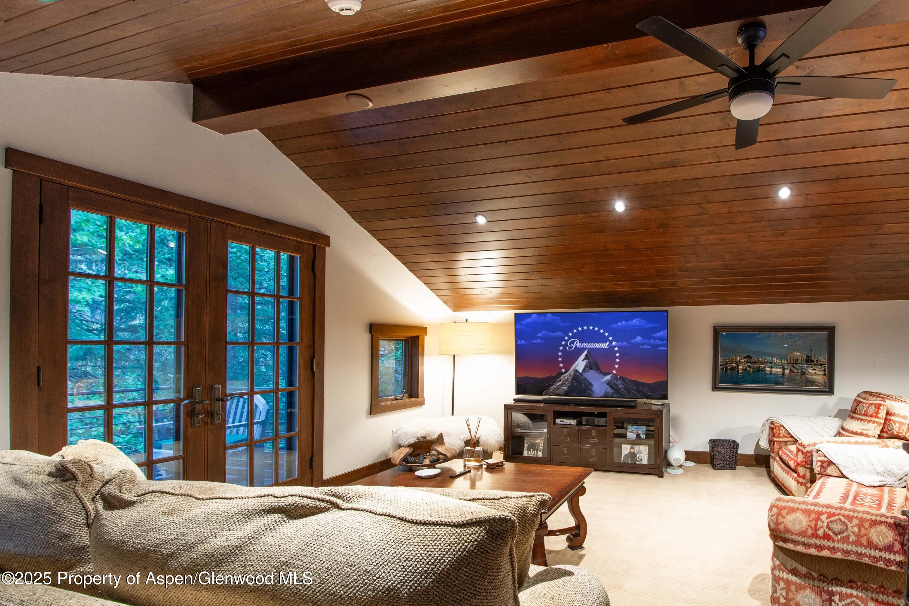 4076 Lower River Road Snowmass, CO 81654 - Photo 44 of 71 a bedroom with furniture and a flat screen tv