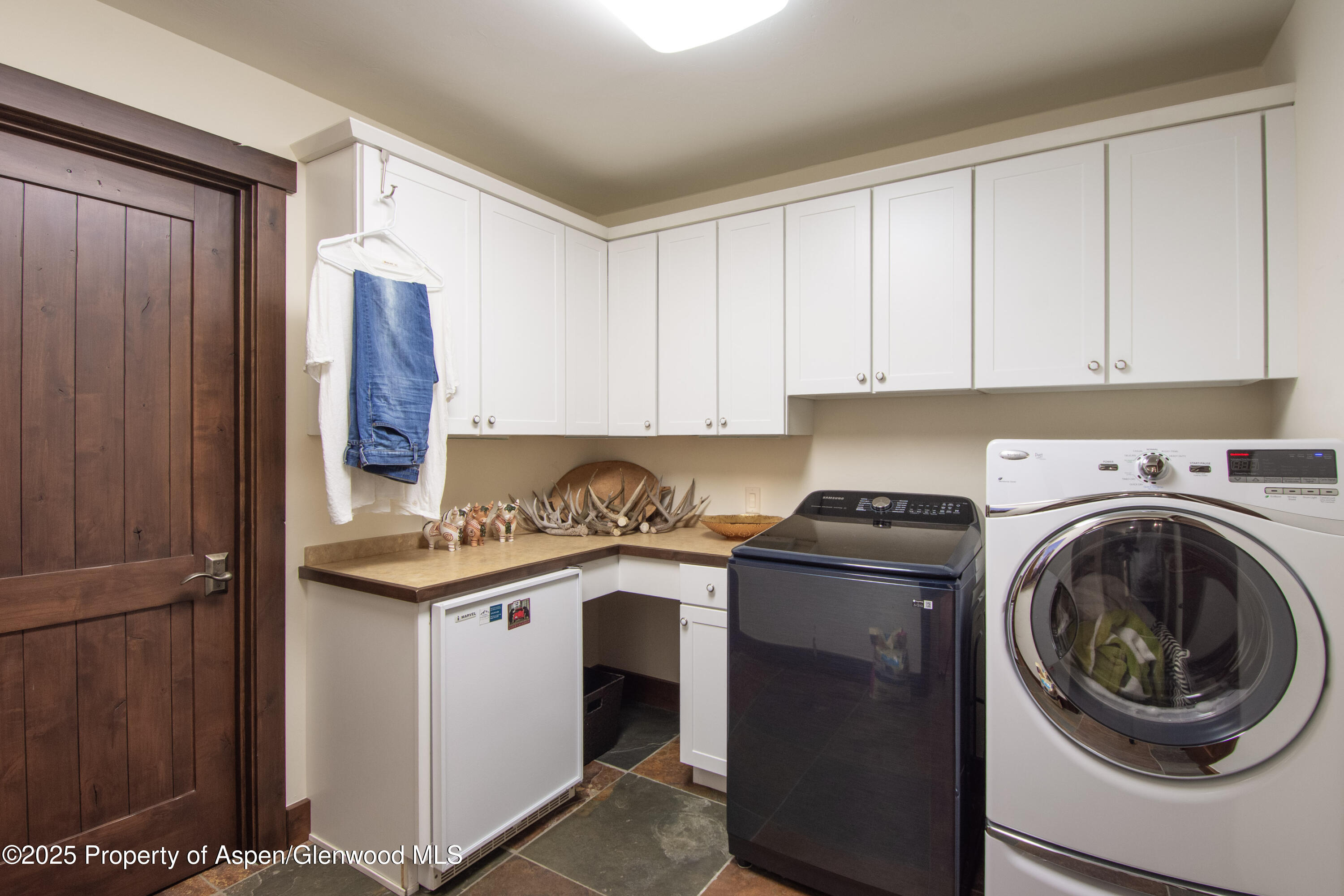 4076 Lower River Road Snowmass, CO 81654 - Photo 46 of 71 a kitchen with stainless steel appliances granite countertop a sink and a stove top oven