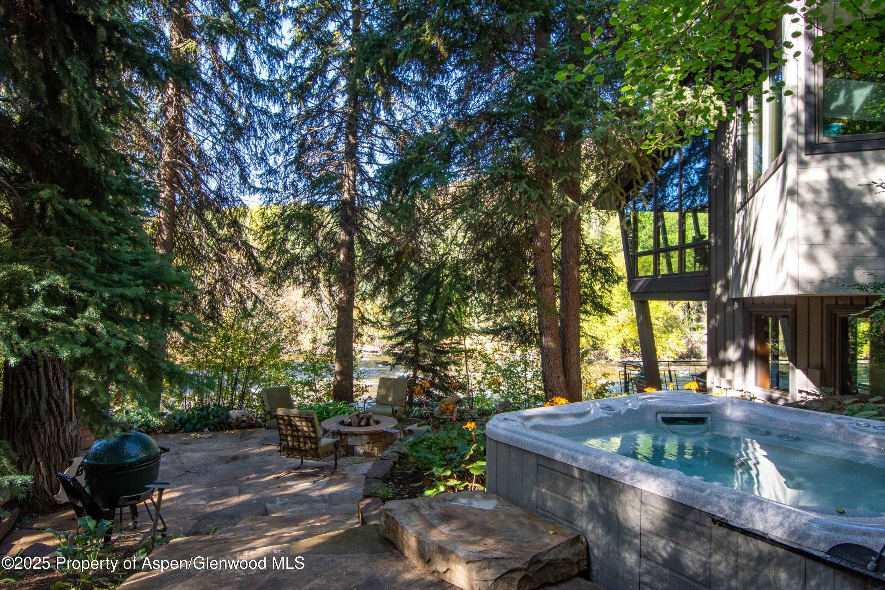 4076 Lower River Road Snowmass, CO 81654 - Photo 52 of 71 a backyard of a house with table and chairs