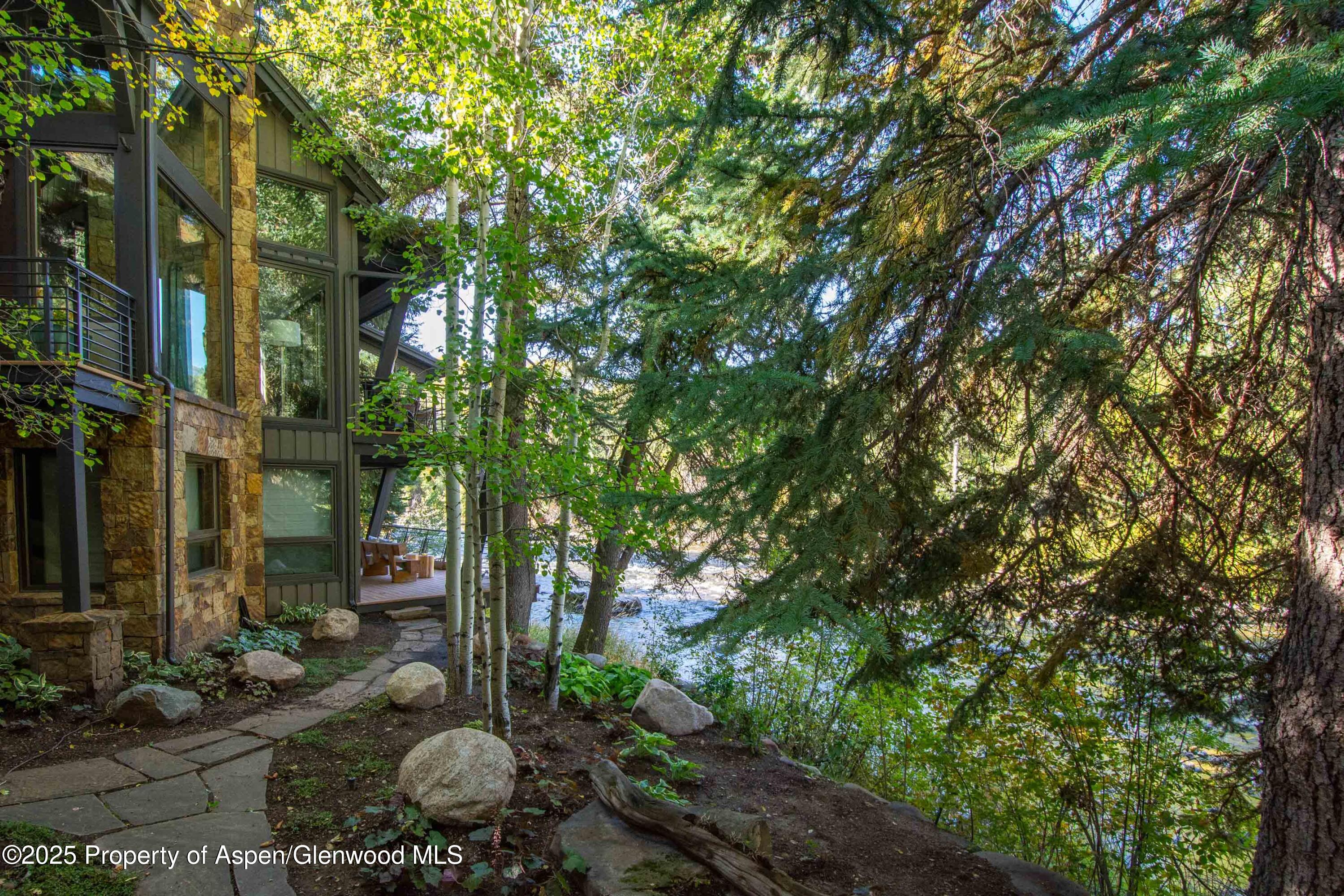 4076 Lower River Road Snowmass, CO 81654 - Photo 62 of 71 a backyard of a house with lots of green space