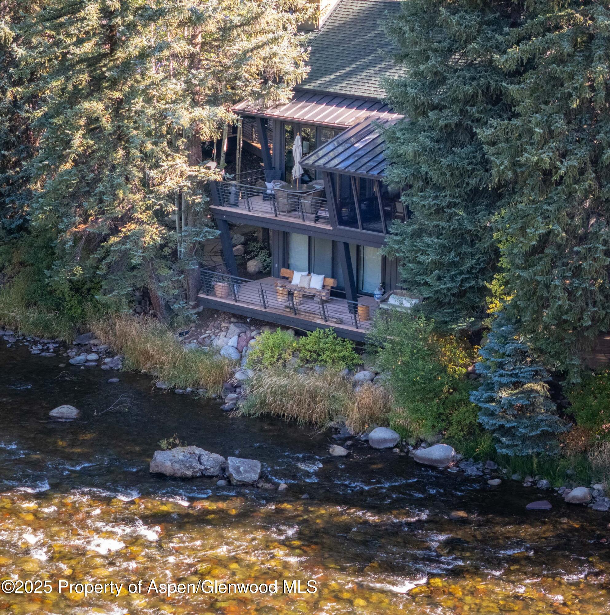 4076 Lower River Road Snowmass, CO 81654 - Photo 66 of 71 a view of a house with a yard