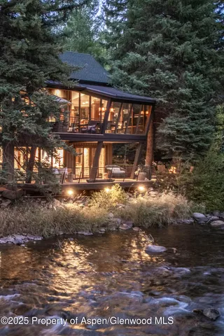 a living room with furniture a large window and a fireplace