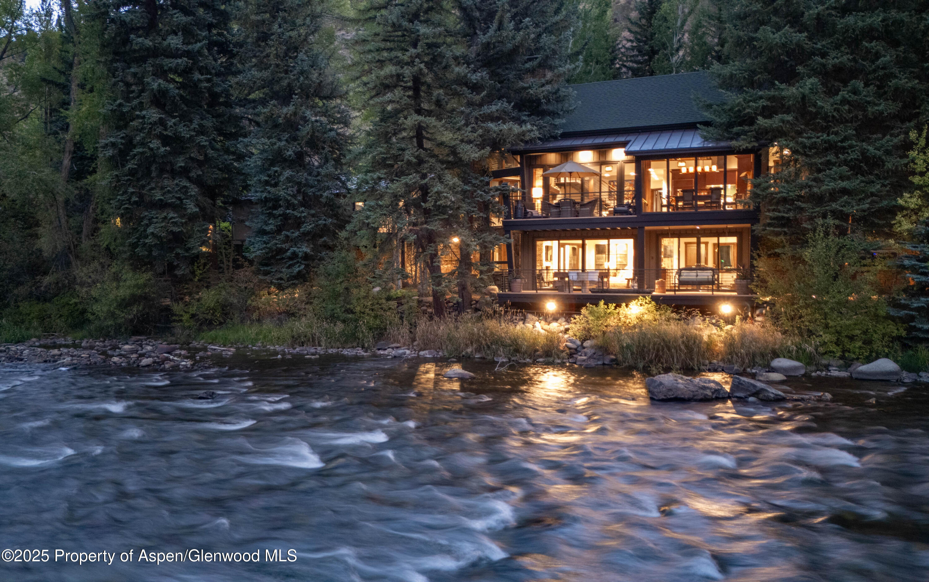 4076 Lower River Road Snowmass, CO 81654 - Photo 9 of 71 a front view of a house with a yard