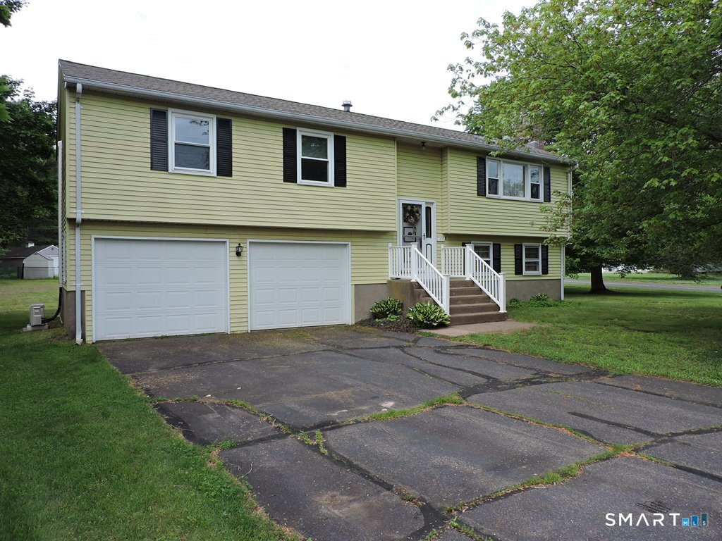 269 Griffin Road South Windsor, CT 06074 - Photo 3 of 36 a front view of a house with a yard and garage