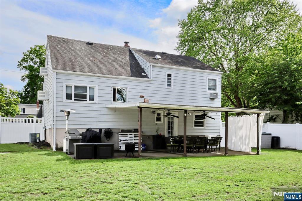 87 Barbara Road Dumont, NJ 07628 - Photo 42 of 48 a view of a house with a yard and a car park in front of it