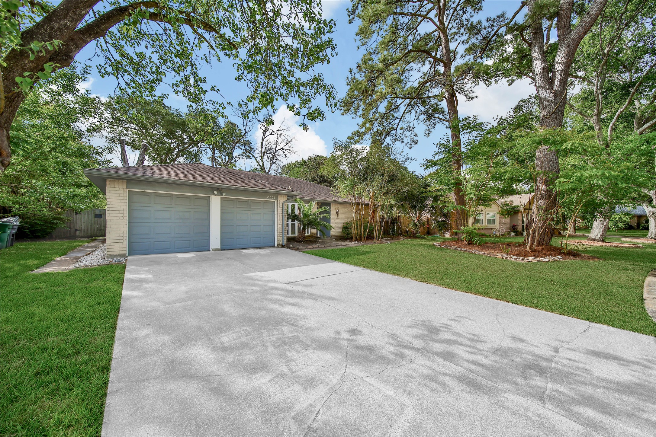 2006 Mermaid Lane Houston, TX 77062 - Photo 31 of 35 front view of a house with a yard and an trees