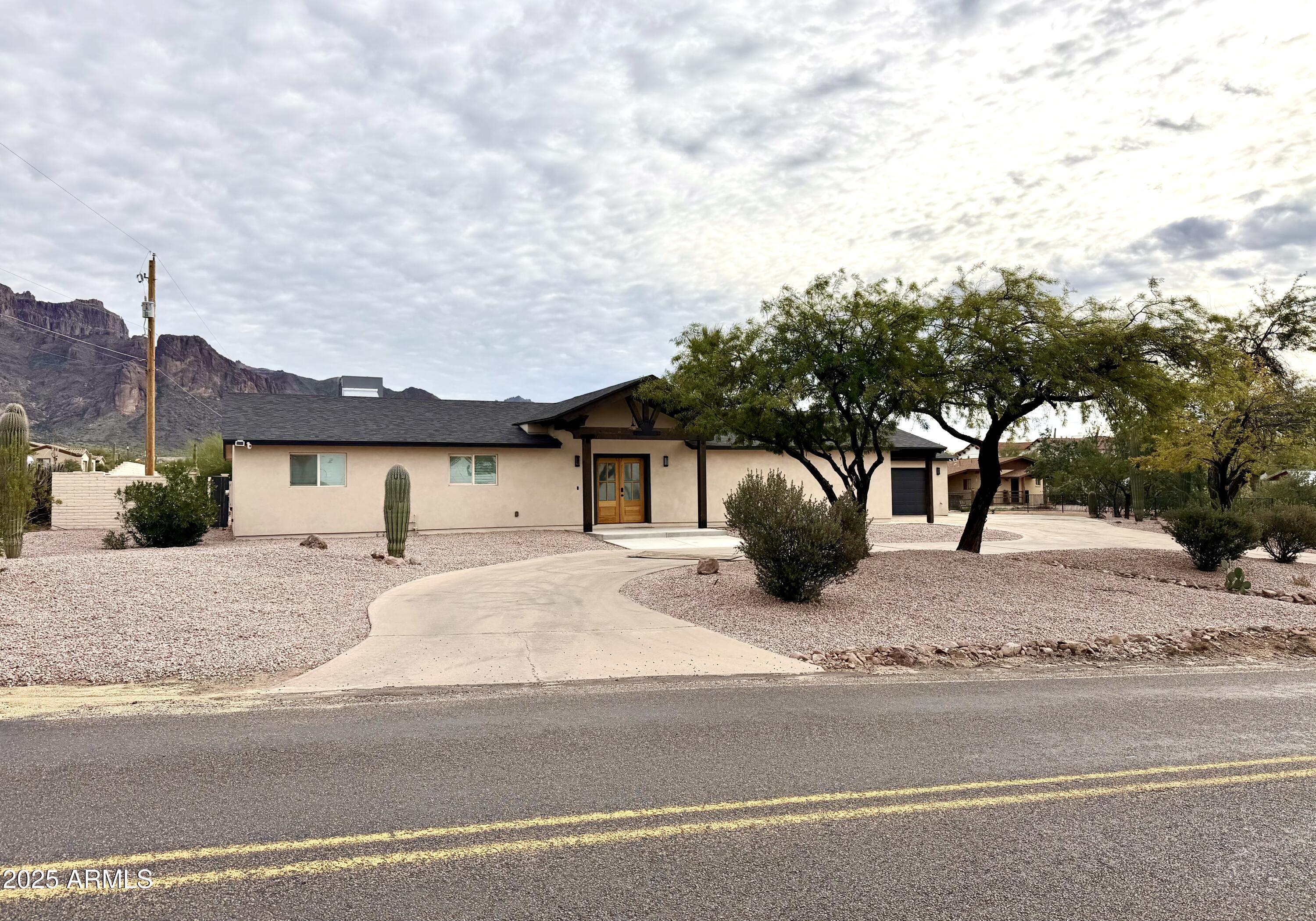 1165 North Mountain View Road Apache Junction, AZ 85119 - Photo 1 of 29 a front view of a house with a yard and garage