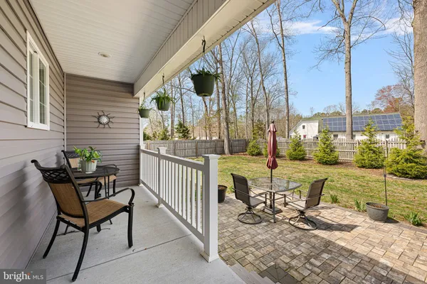 a view of a chair and tables in the patio