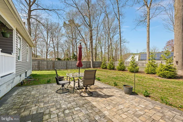 a view of a chair and tables in the patio