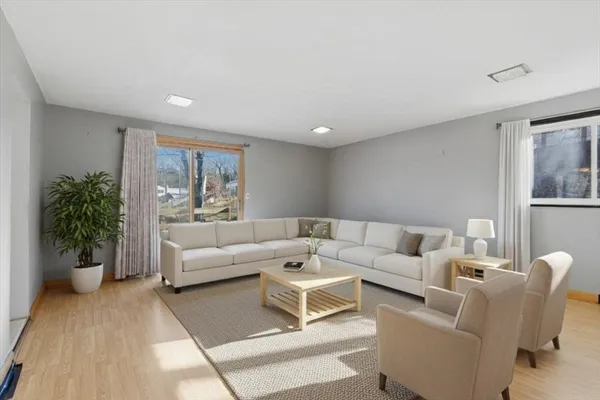 a living room with furniture and a potted plant