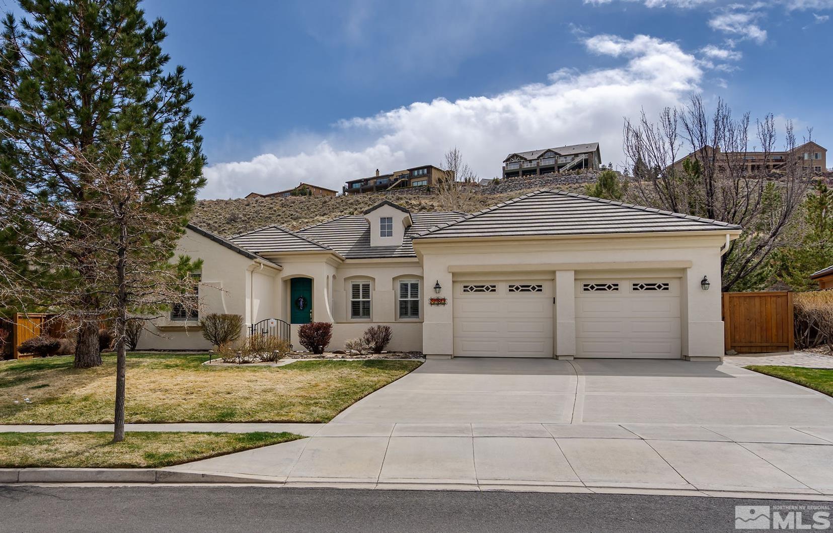 8180 Willow Ranch Trail Reno, NV 89523 - Photo 1 of 31 a view of a white house with a iron fence
