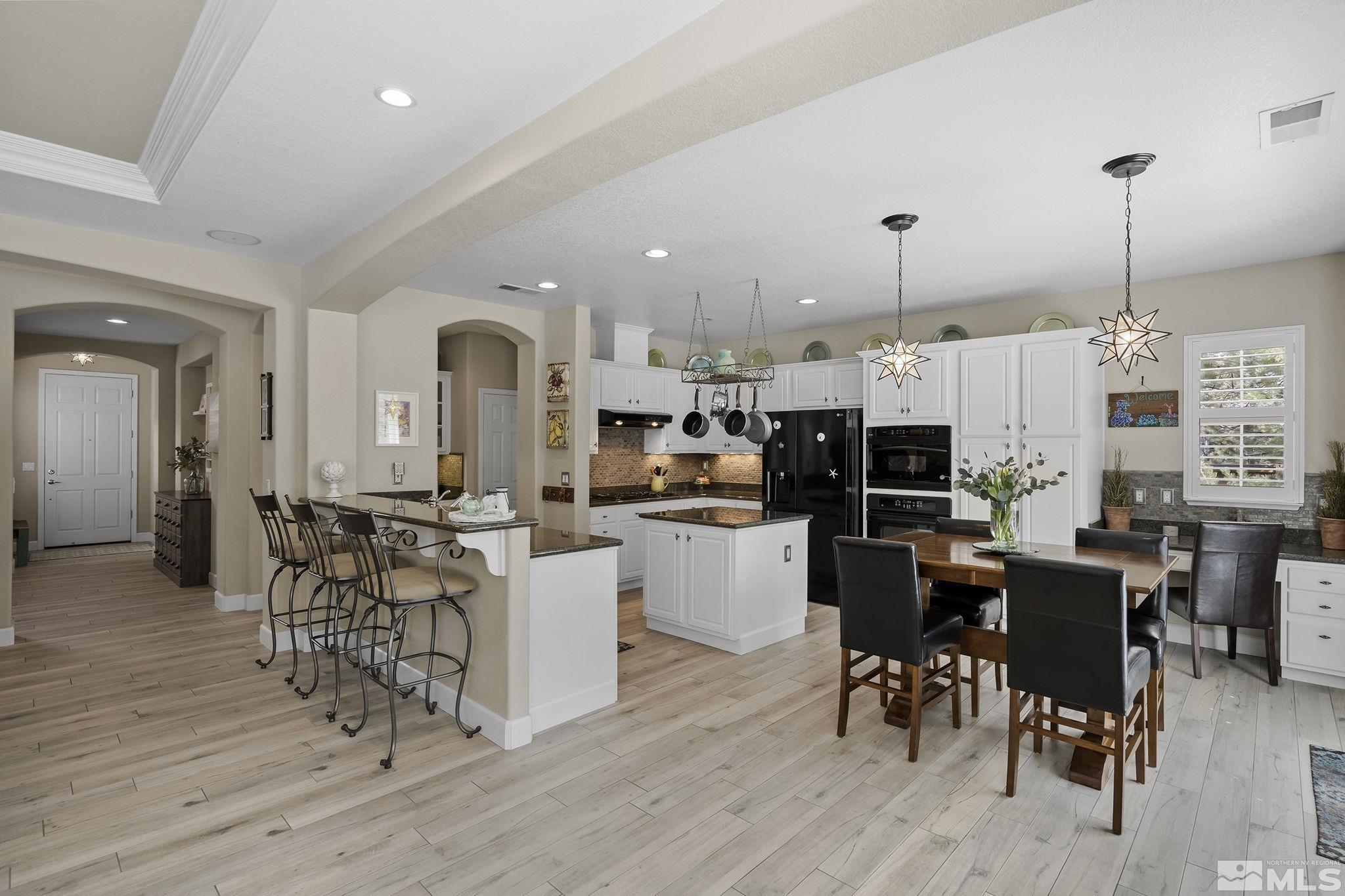 8180 Willow Ranch Trail Reno, NV 89523 - Photo 11 of 31 a view of kitchen with dining table chairs and wooden floor