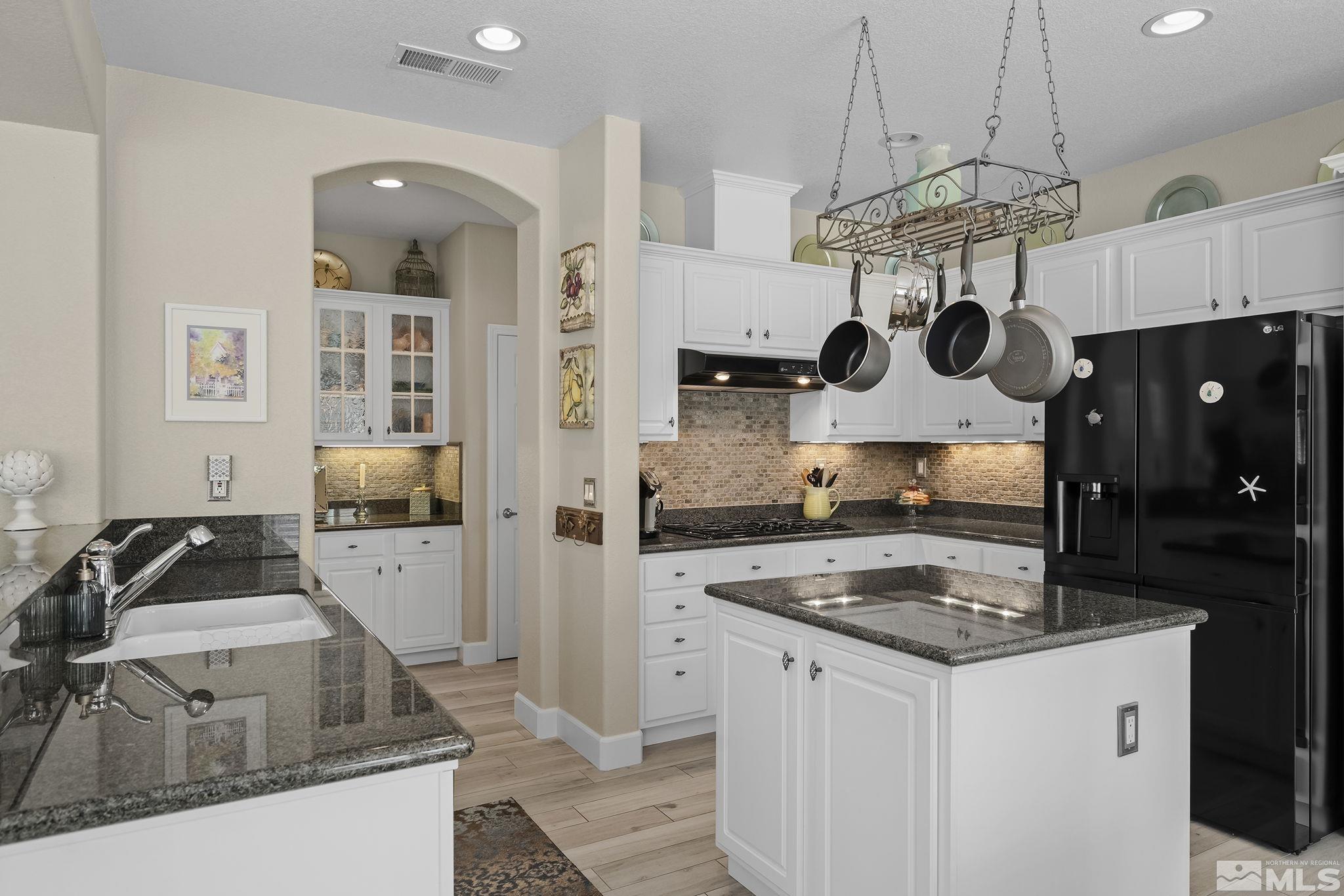 8180 Willow Ranch Trail Reno, NV 89523 - Photo 12 of 31 a kitchen with a sink a stove and cabinets