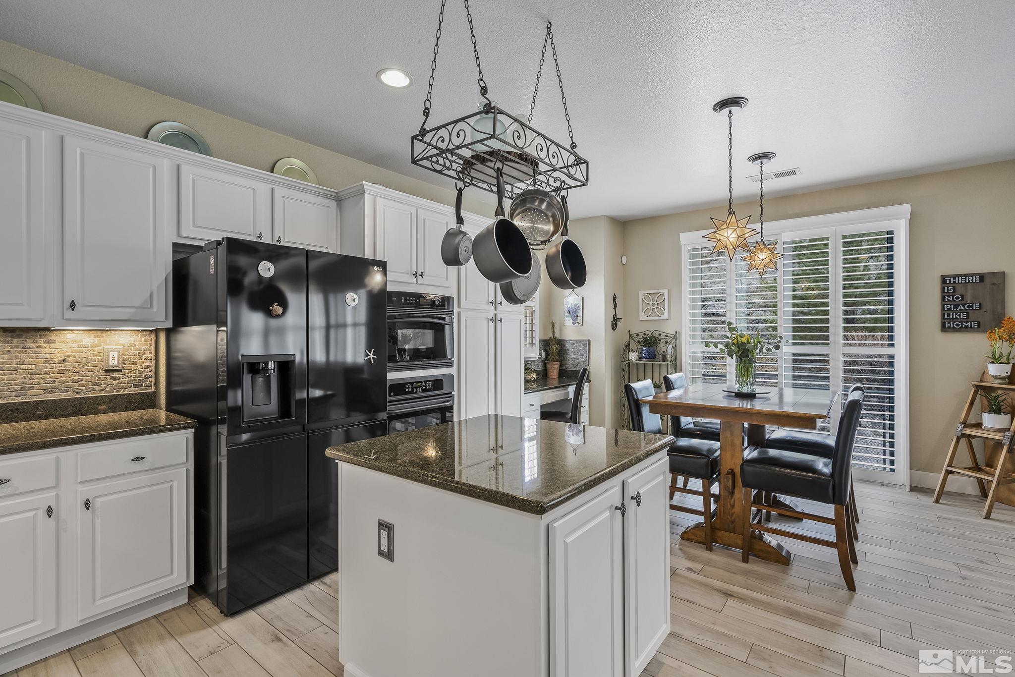 8180 Willow Ranch Trail Reno, NV 89523 - Photo 14 of 31 a kitchen with stainless steel appliances granite countertop a stove and refrigerator