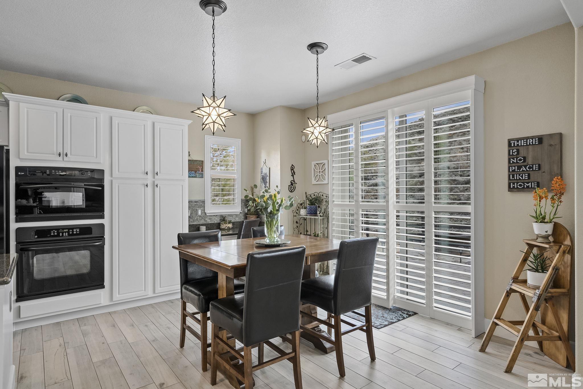 8180 Willow Ranch Trail Reno, NV 89523 - Photo 15 of 31 a view of a dining room with furniture window and wooden floor
