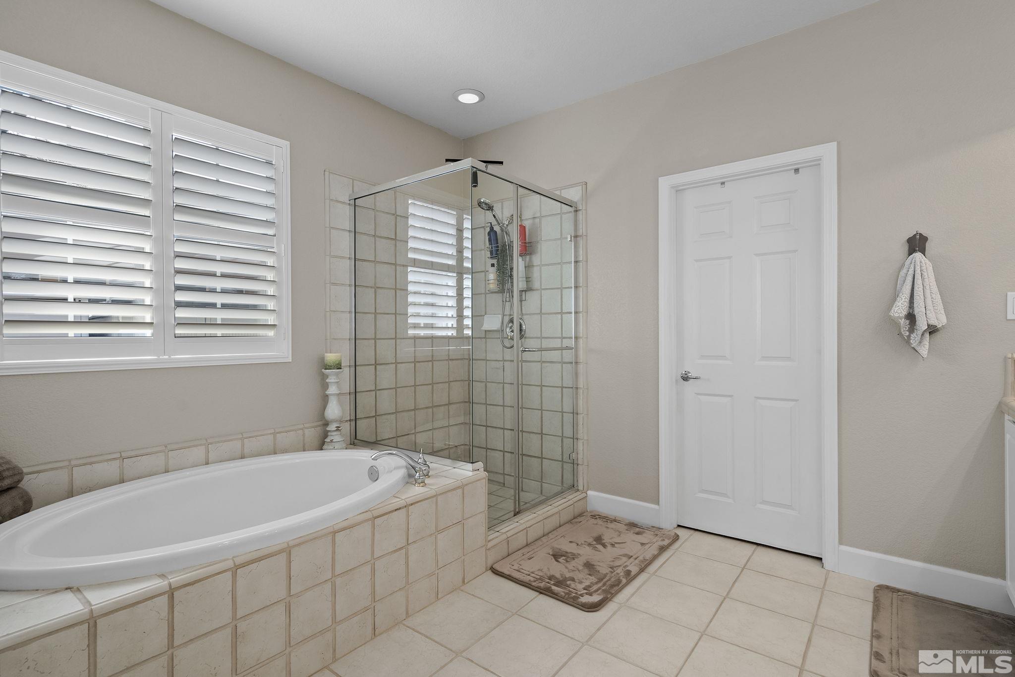 8180 Willow Ranch Trail Reno, NV 89523 - Photo 18 of 31 a bathroom with a bathtub and shower