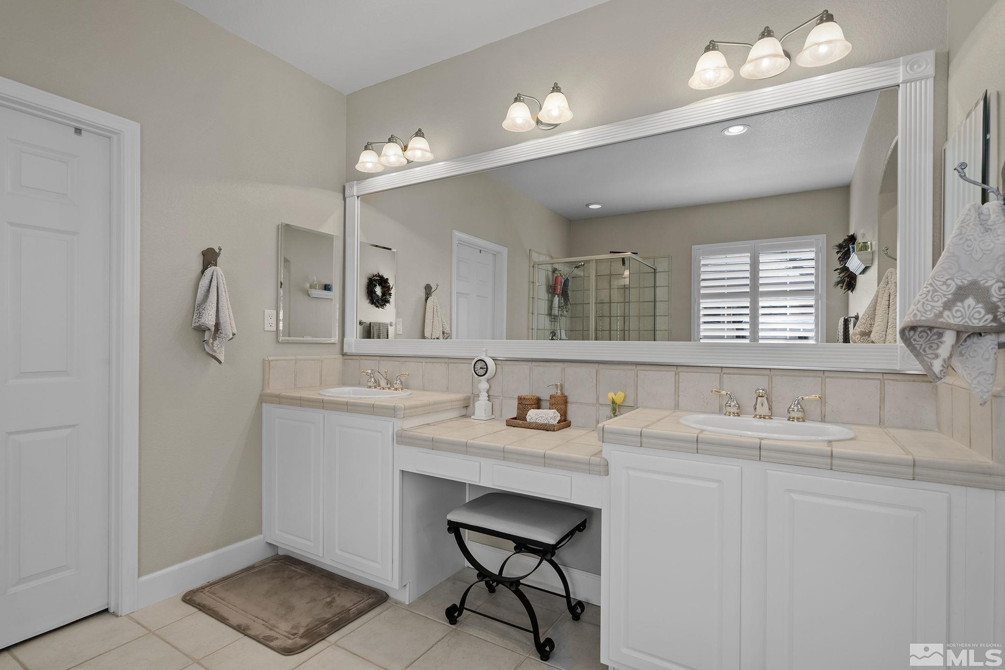 8180 Willow Ranch Trail Reno, NV 89523 - Photo 19 of 31 a bathroom with a sink double vanity and a mirror