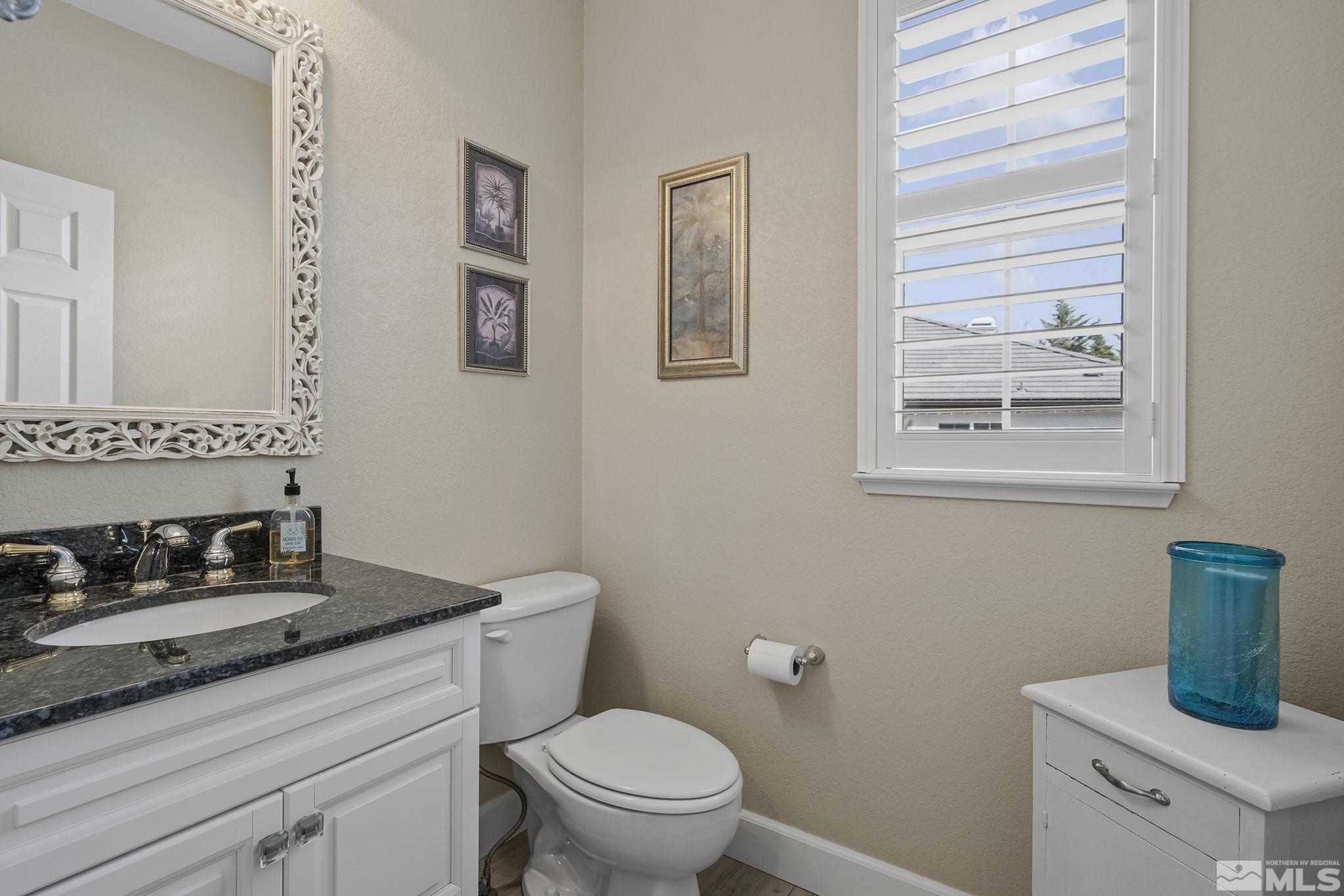 8180 Willow Ranch Trail Reno, NV 89523 - Photo 23 of 31 a bath room with a toilet a sink and a window