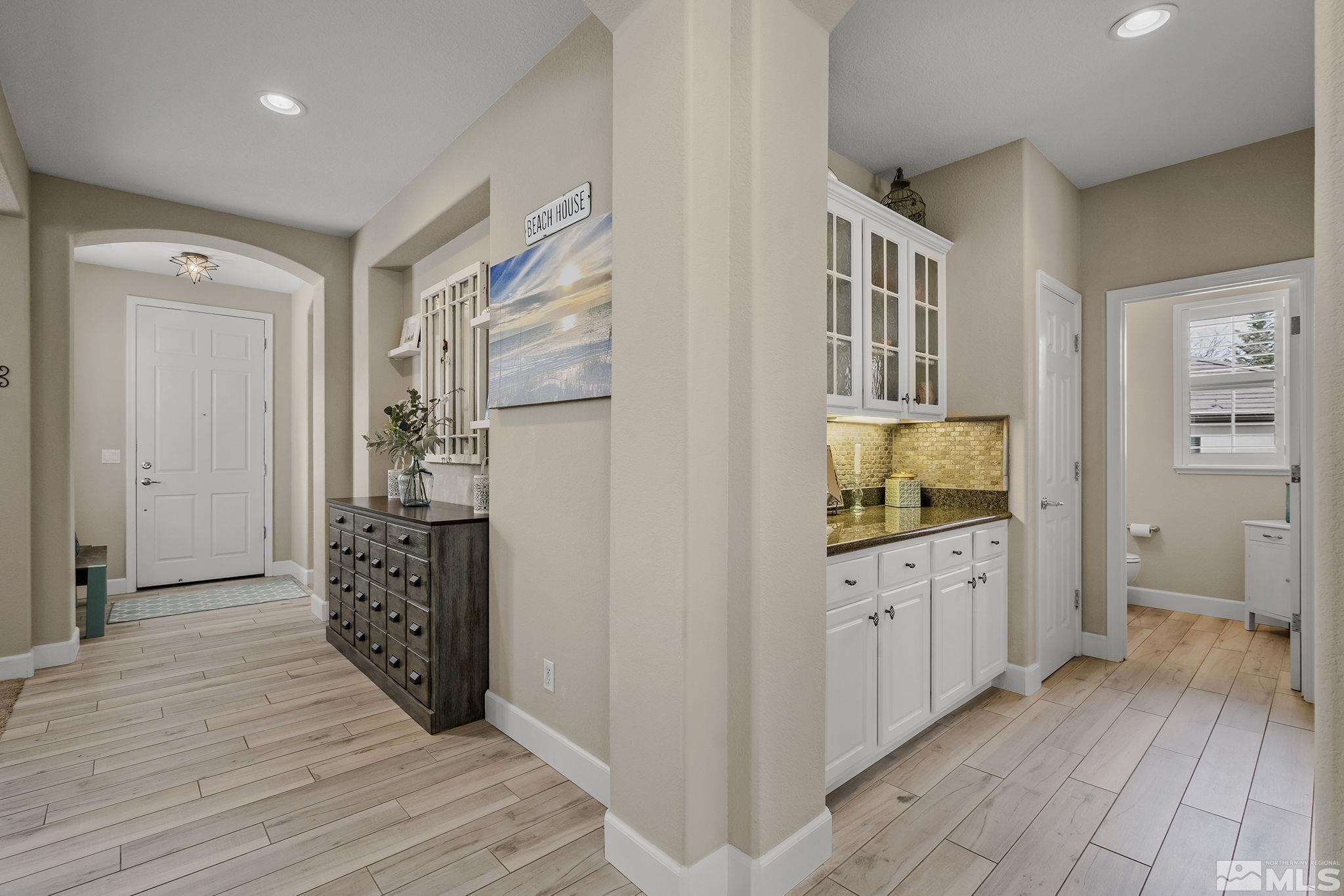 8180 Willow Ranch Trail Reno, NV 89523 - Photo 6 of 31 a view of a hallway with wooden floor and furniture