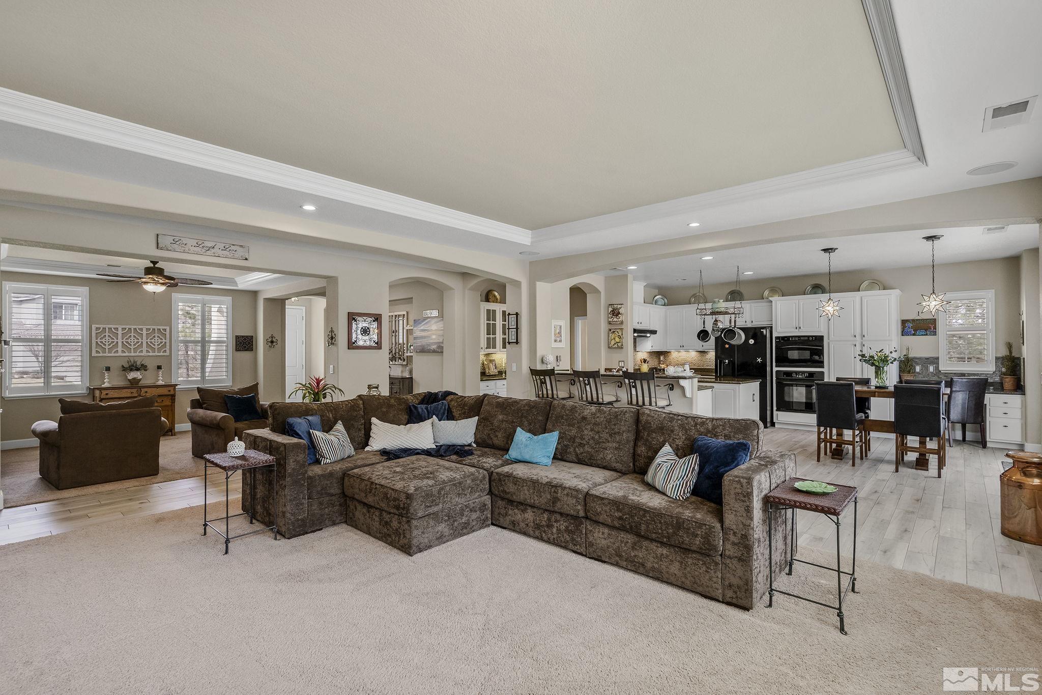 8180 Willow Ranch Trail Reno, NV 89523 - Photo 10 of 31 a living room with furniture kitchen view and a chandelier