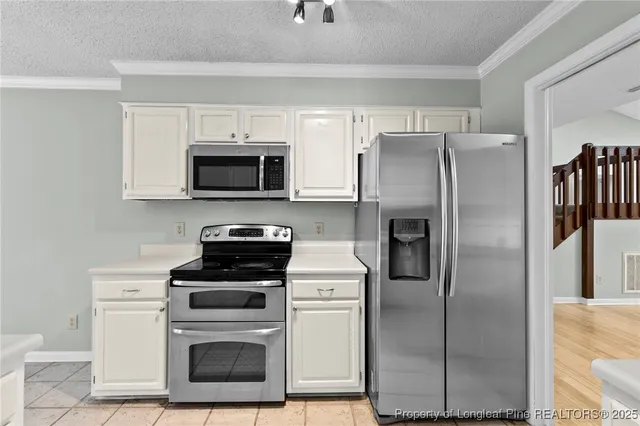 a kitchen with a refrigerator stove and microwave
