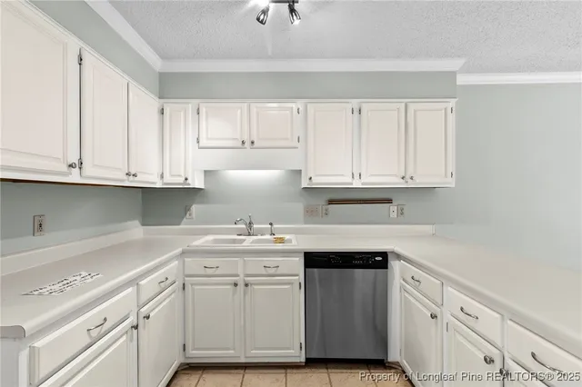a kitchen with cabinets appliances a sink and a counter top