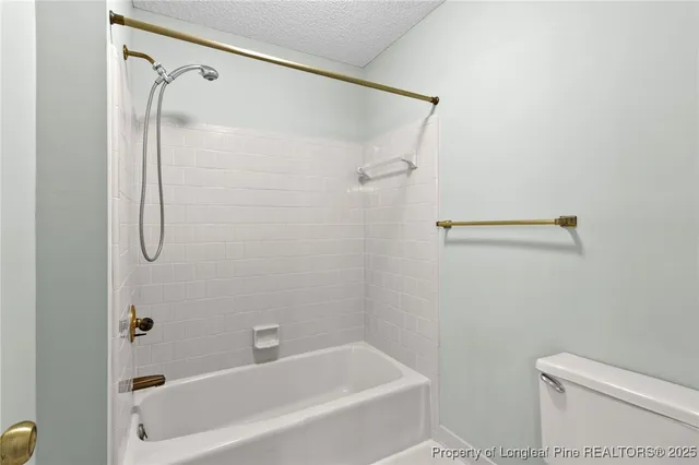 a bathroom with a shower and a toilet