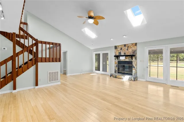 a view of an empty room with window and fireplace