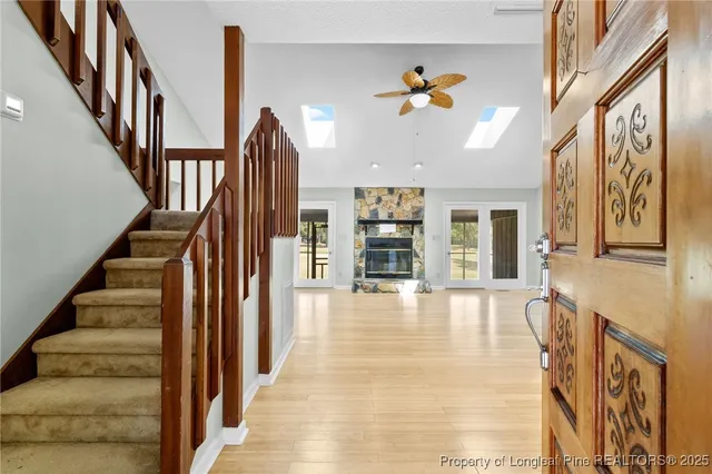 a view of an entryway with wooden floor and windows