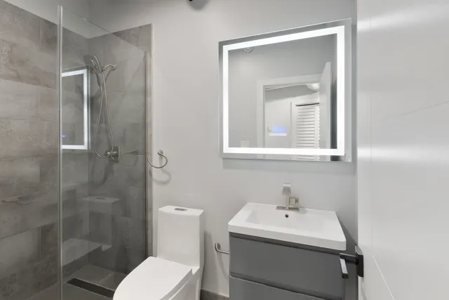 a bathroom with a sink toilet and shower