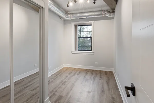 a view of an empty room and wooden floor