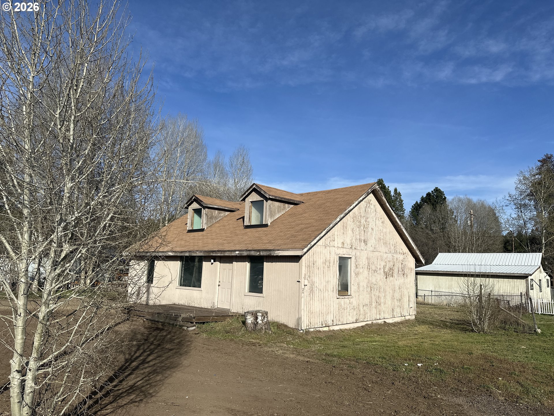 136863 Highway 97 Crescent, OR 97733 - Photo 2 of 19 a front view of a house with a yard and garage