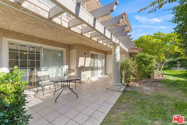 a view of a house with backyard porch and sitting area