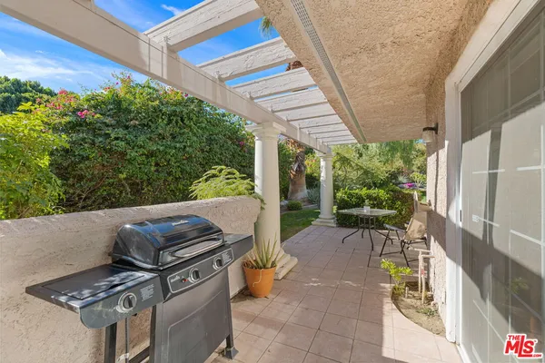 a view of a patio with table and chairs and potted plants