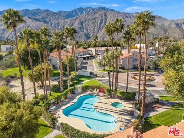 a view of a swimming pool with a yard and mountain view