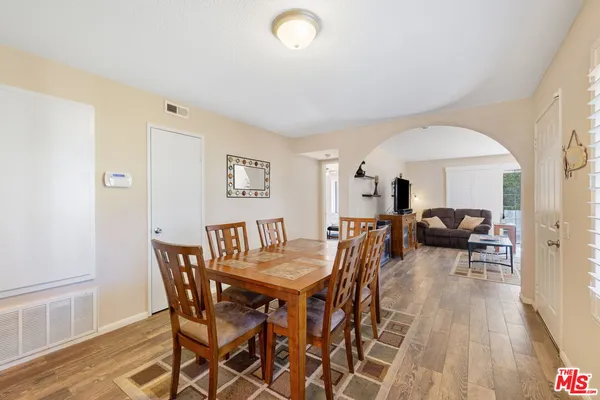 a view of a dining room with furniture and wooden floor