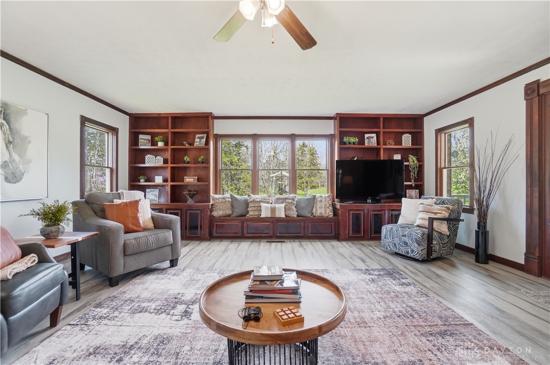 7553 Coffin Station Road Springfield, OH 45502 - Photo 27 of 95 This inviting living area features warm wood built-ins and abundant natural light.
