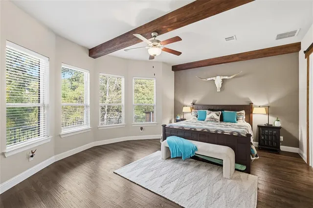 a bedroom with a bed a window and potted plant