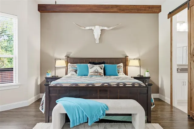 a bedroom with a bed and a flat screen tv