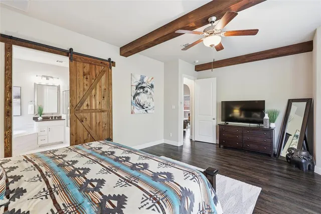 a bathroom with a double vanity sink a toilet a mirror and shower