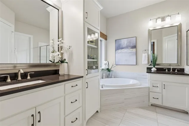 a bathroom with a shower sink and mirror