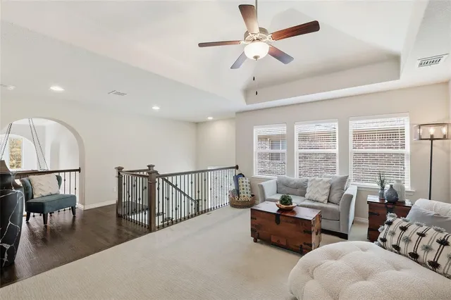 a spacious bedroom with a bed a couch and a large window