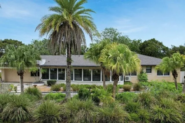 a front view of a house with a garden