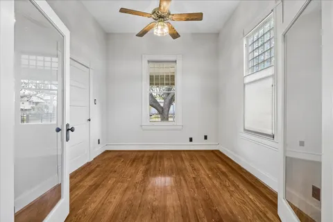 a living room with a bed furniture and a large window