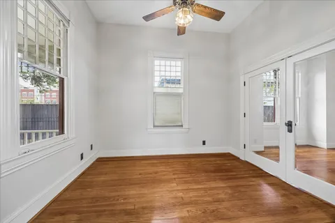 wooden floor in an empty room with a window